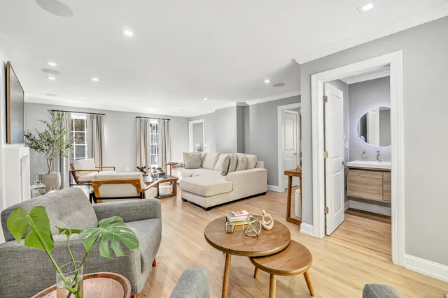 a living room with furniture and wooden floor