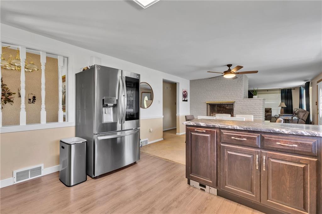 602 Circle Drive Rochester, PA 15074 - Photo 11 of 28 a kitchen with kitchen island a counter top space a sink and stainless steel appliances