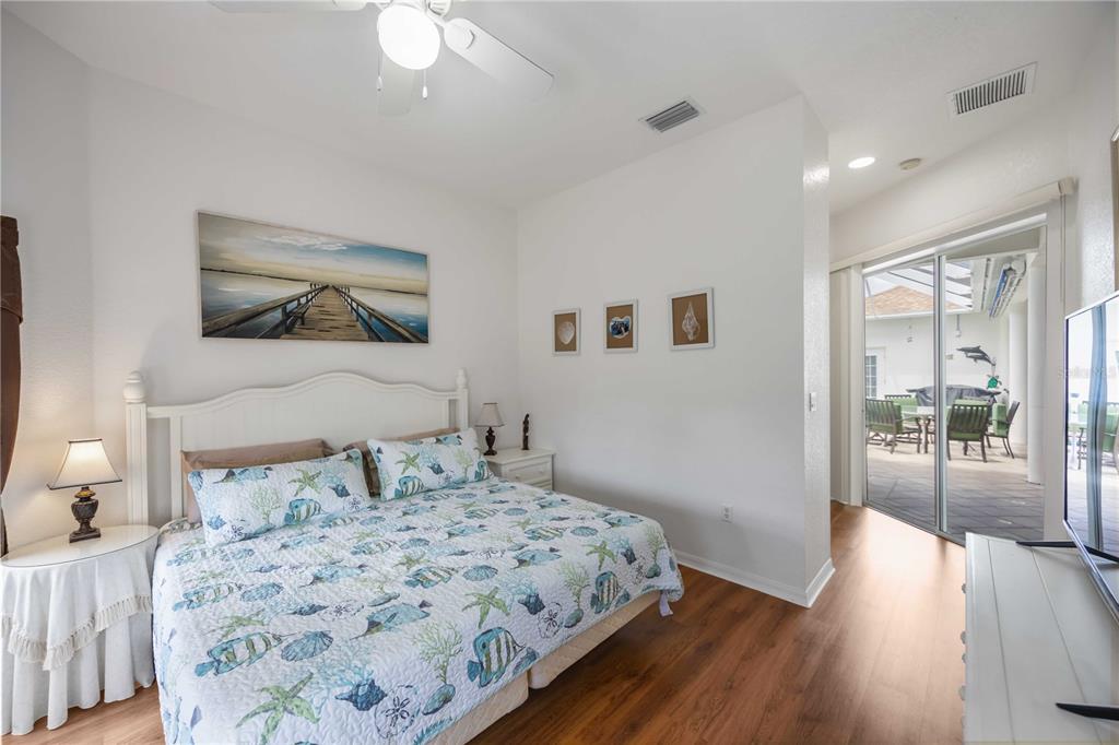 48 Bunker Road Rotonda West, FL 33947 - Photo 38 of 59 a bedroom with a bed and a painting on the wall