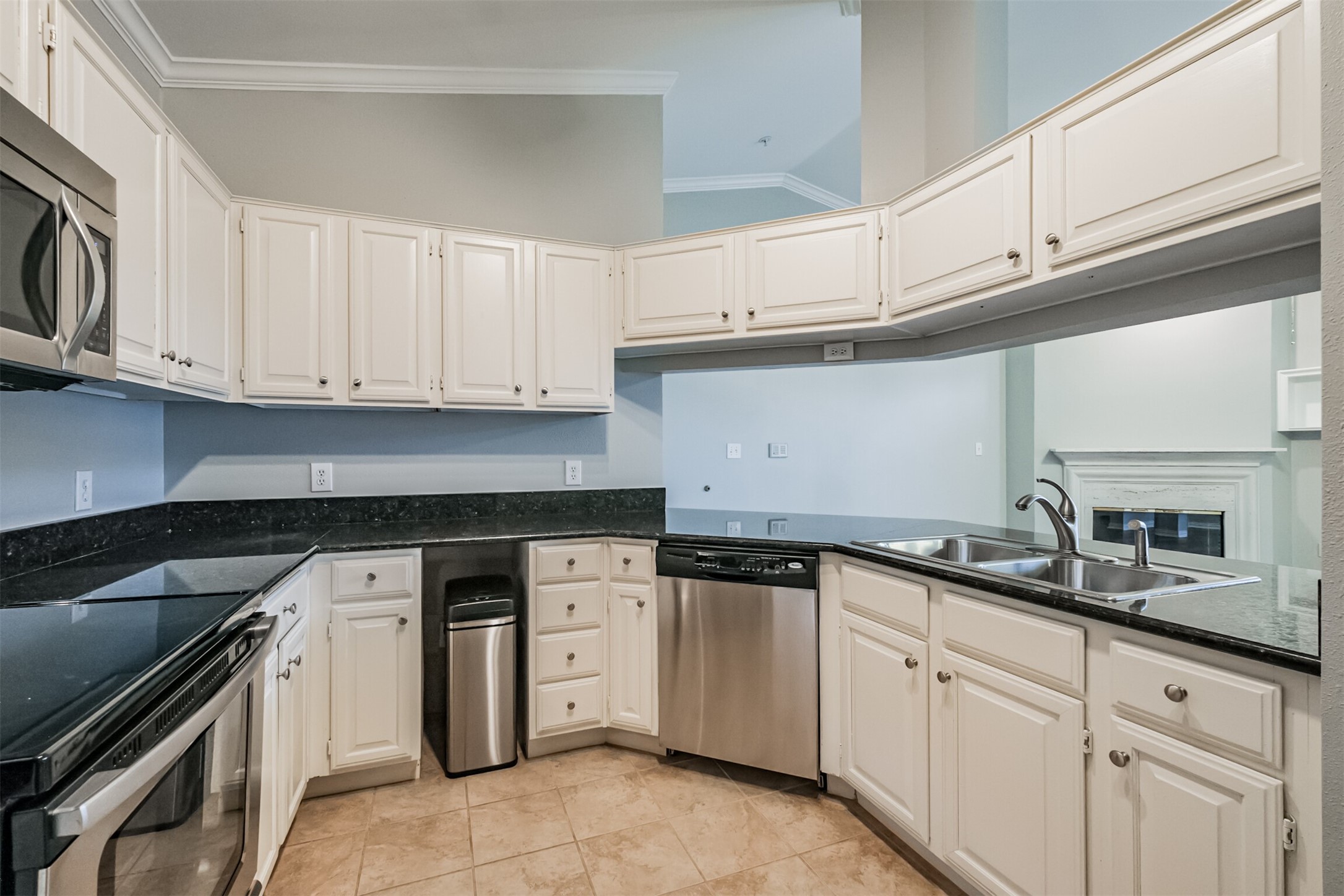 2111 Welch Street, Unit B304 Houston, TX 77019 - Photo 14 of 37 a kitchen with white cabinets and a stove