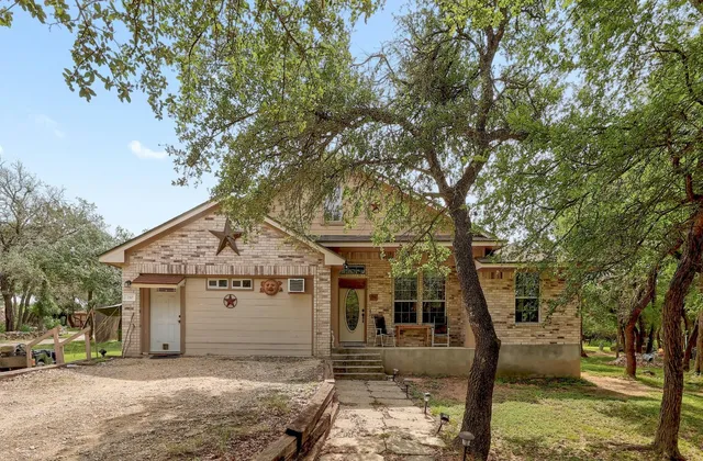 a view of a house with a tree in the background