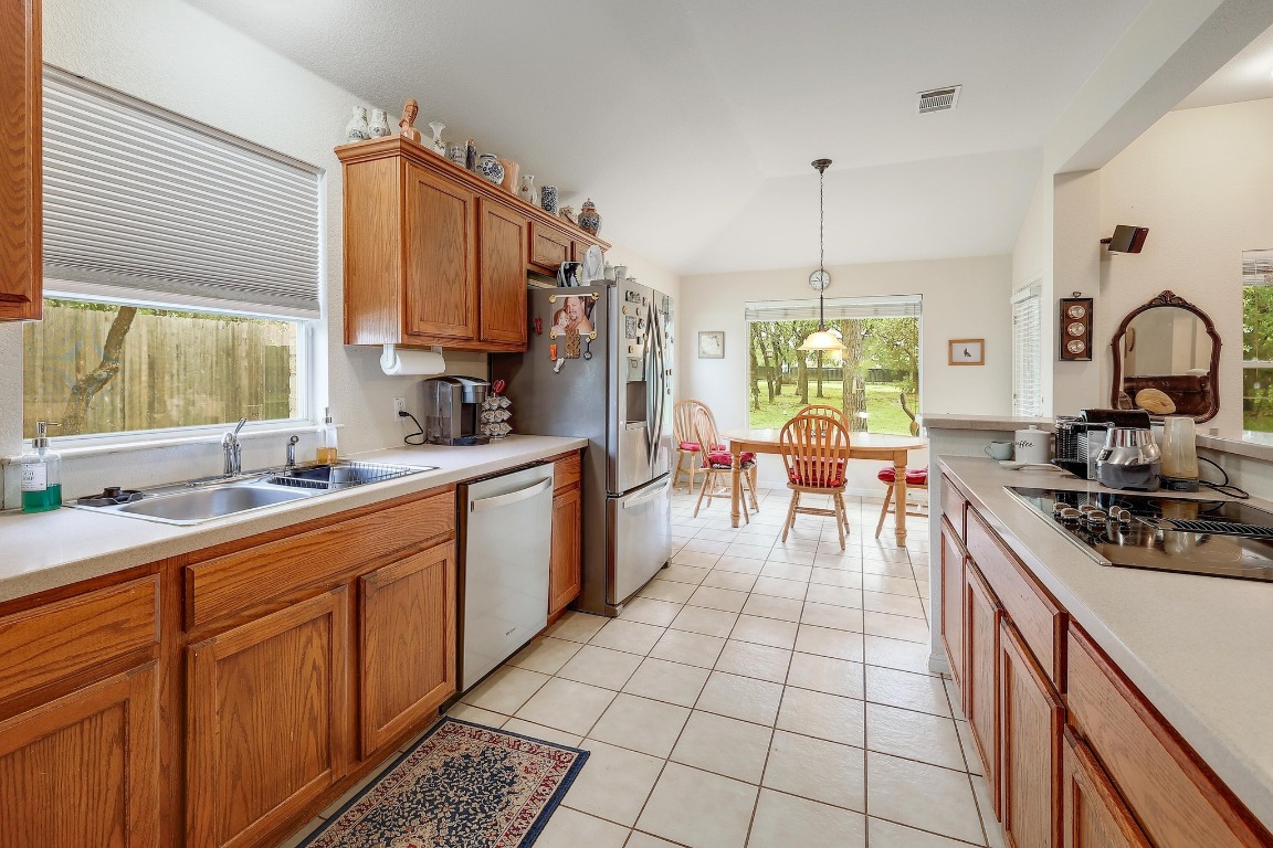 210 Buoy Circle Georgetown, TX 78633 - Photo 10 of 32 a kitchen with stainless steel appliances a sink stove and cabinets