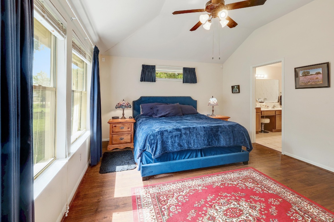 210 Buoy Circle Georgetown, TX 78633 - Photo 14 of 32 a bedroom with a large bed and a chandelier