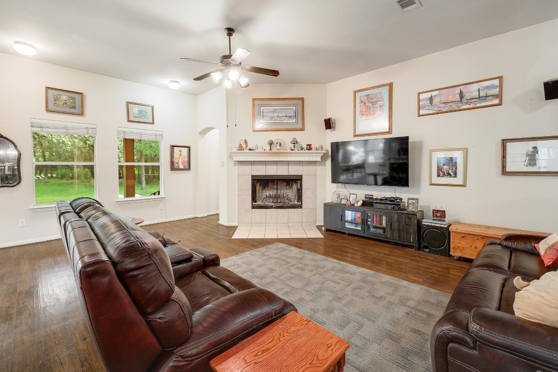 210 Buoy Circle Georgetown, TX 78633 - Photo 5 of 32 a living room with furniture a flat screen tv and a fireplace