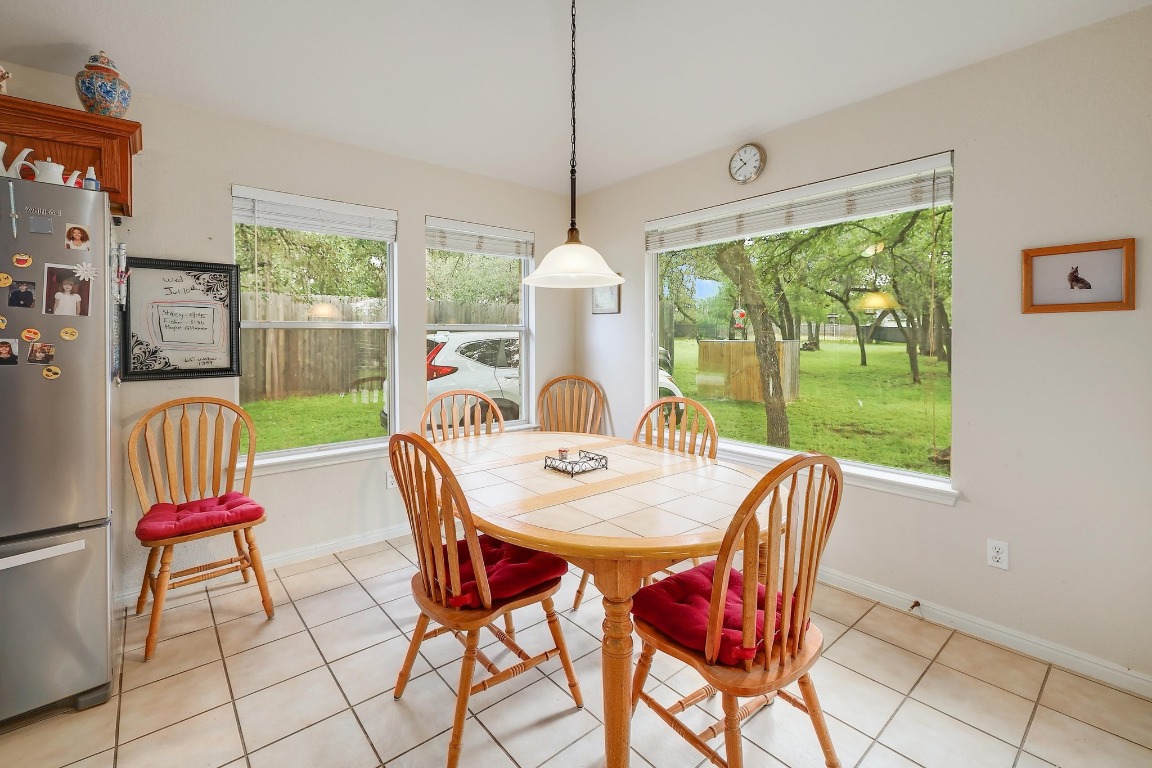 210 Buoy Circle Georgetown, TX 78633 - Photo 6 of 32 a dining room with furniture a chandelier and wooden floor