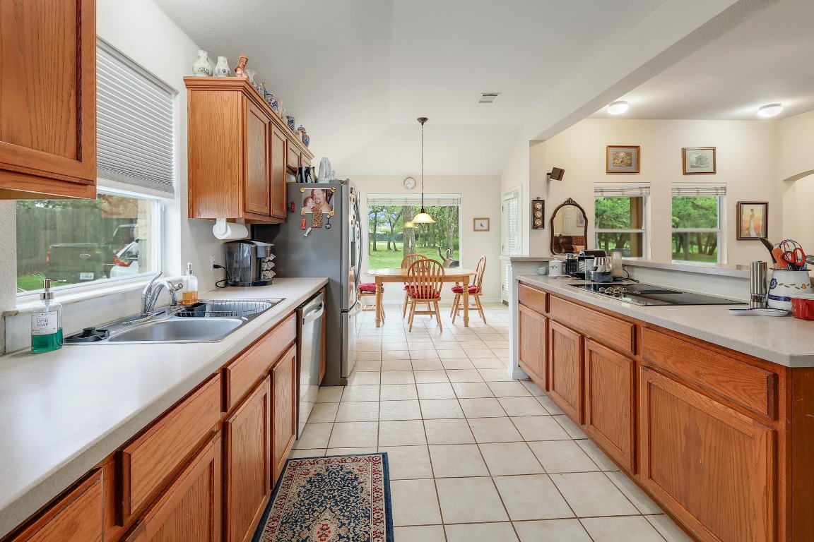 210 Buoy Circle Georgetown, TX 78633 - Photo 9 of 32 a kitchen with stainless steel appliances a sink stove and cabinets