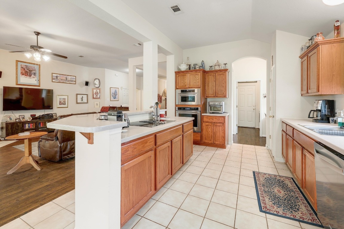 210 Buoy Circle Georgetown, TX 78633 - Photo 32 of 32 a kitchen with stainless steel appliances a sink counter space cabinets and a counter top space