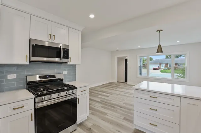 a kitchen with a stove and a microwave