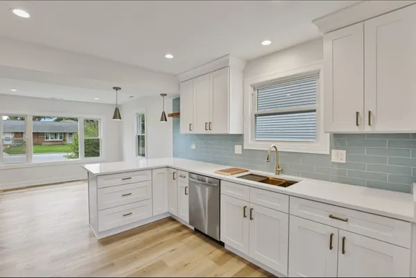 a kitchen that has a sink and a stove