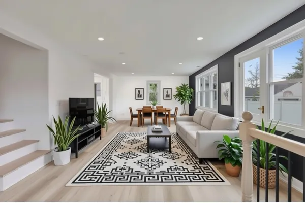 a living room with furniture potted plant and a flat screen tv