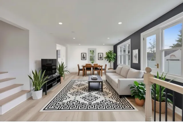 a living room with furniture potted plant and a flat screen tv