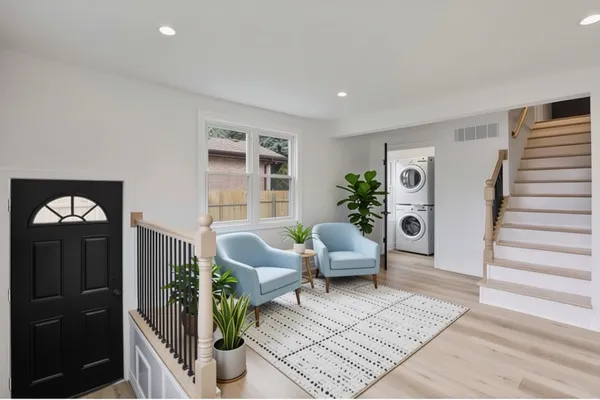 a living room with furniture and wooden floor