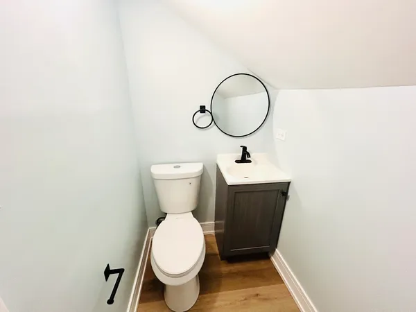 a bathroom with a toilet sink and a mirror