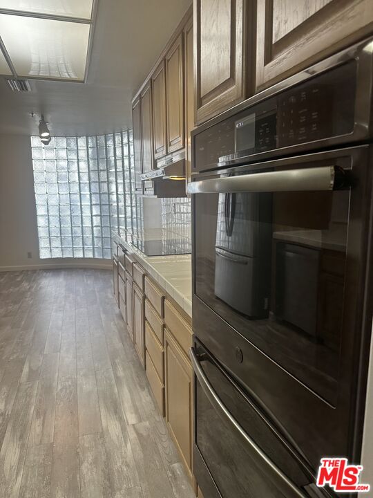 2122 Century Park Lane, Unit 312 Los Angeles, CA 90067 - Photo 11 of 44 a kitchen with kitchen island granite countertop a stove and a sink