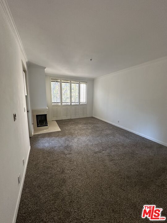 2122 Century Park Lane, Unit 312 Los Angeles, CA 90067 - Photo 18 of 44 an empty room with windows and fireplace