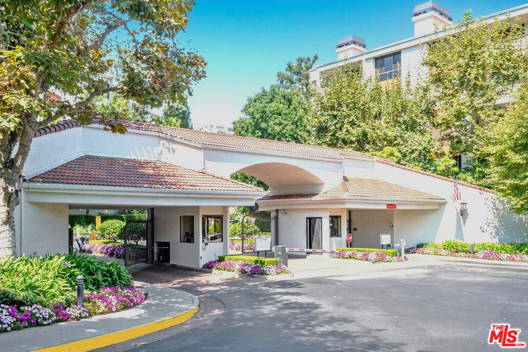 2122 Century Park Lane, Unit 312 Los Angeles, CA 90067 - Photo 2 of 44 a view of a patio with a table and chairs under an umbrella