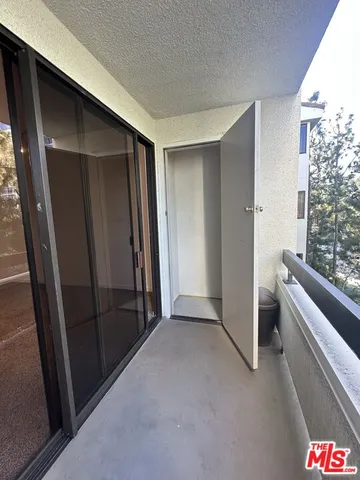 an empty room with large windows