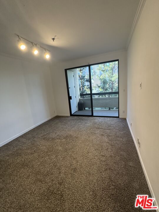 2122 Century Park Lane, Unit 312 Los Angeles, CA 90067 - Photo 30 of 44 a view of an empty room with a floor to ceiling window and a ceiling fan