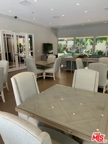 a view of a tennis ground with large trees