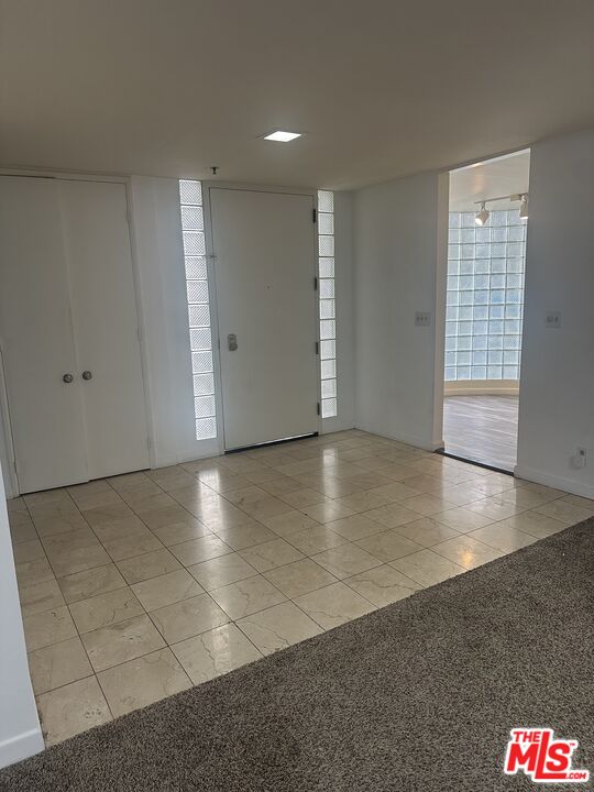 2122 Century Park Lane, Unit 312 Los Angeles, CA 90067 - Photo 8 of 44 an empty room with wooden floor and windows