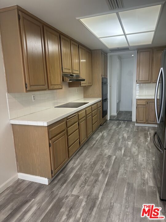 2122 Century Park Lane, Unit 312 Los Angeles, CA 90067 - Photo 10 of 44 a kitchen with stainless steel appliances granite countertop a sink a stove and cabinets