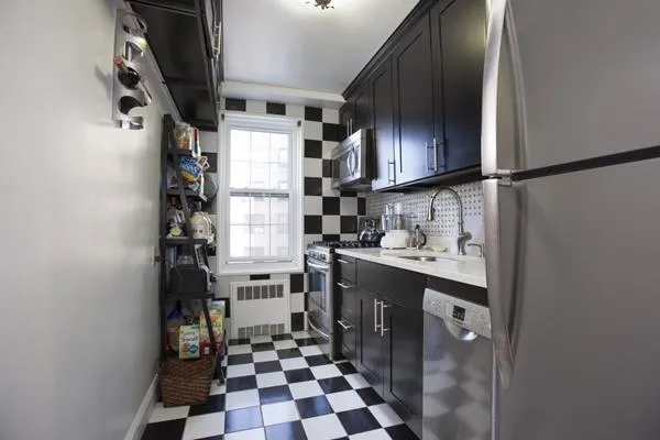 a kitchen with a sink a refrigerator and cabinets