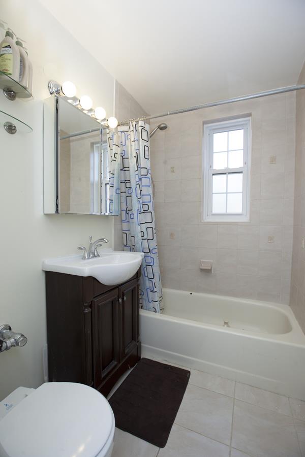140-21 Burden Crescent, Unit 306 Queens, NY 11435 - Photo 5 of 5 a bathroom with a sink a toilet and shower