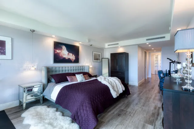 a bedroom with bed and a night stand