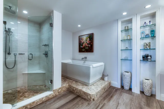 a view of a bathroom with a bathtub and shower