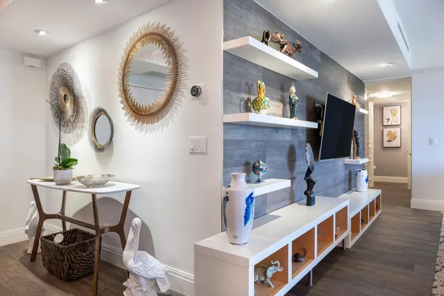 a living room with furniture and a mirror