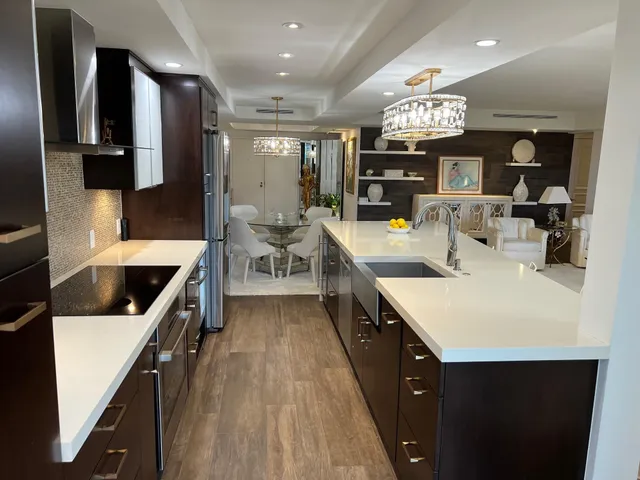 a kitchen with a sink a counter top space and stainless steel appliances