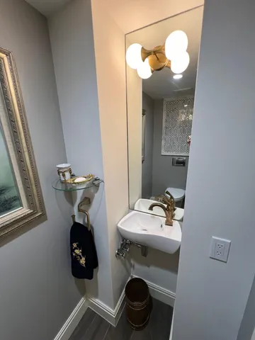 a bathroom with a sink mirror and toilet