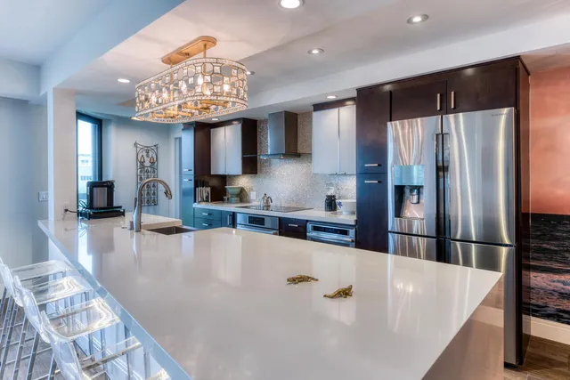 a large kitchen with a large window and stainless steel appliances