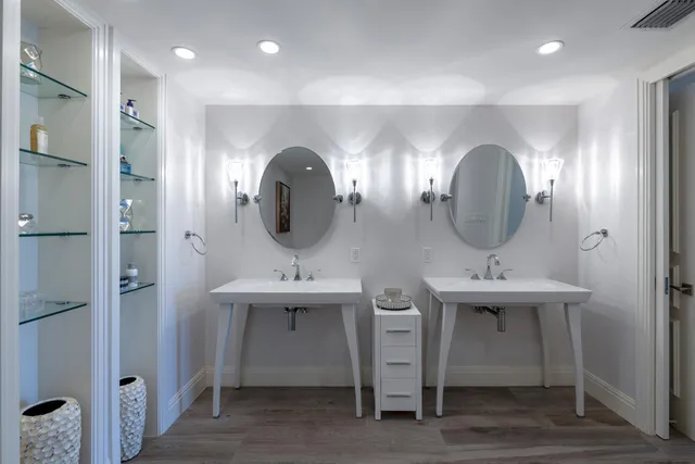 a bathroom with double vanity sinks and a mirror