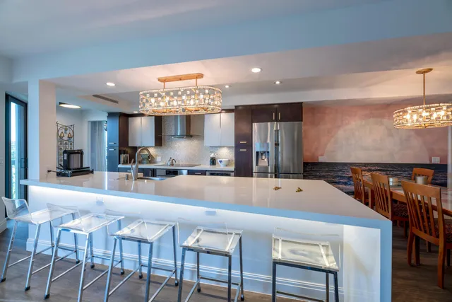 a large kitchen with a table and chairs