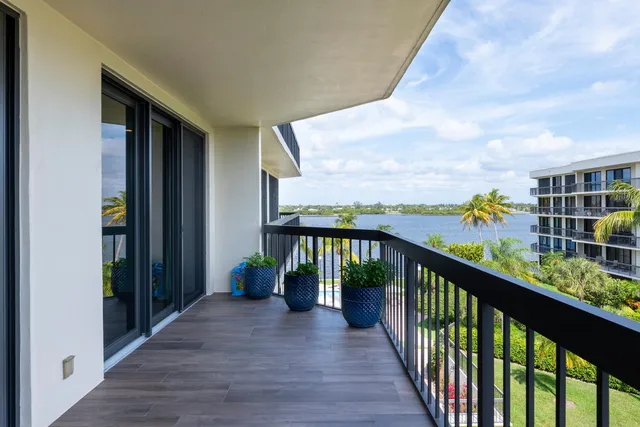 a view of a balcony with wooden floor and fence