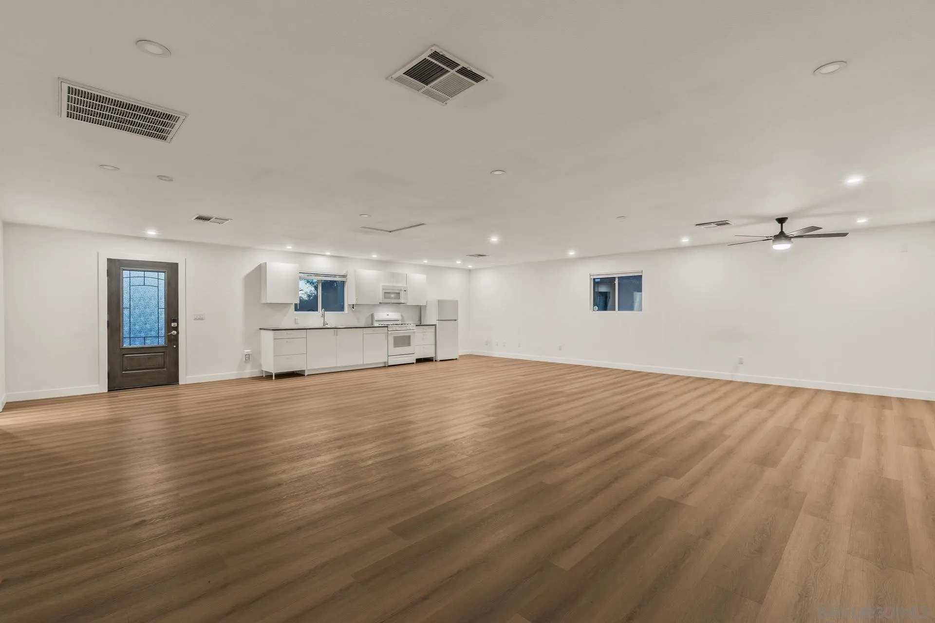 539 Steffy Road Ramona, CA 92065 - Photo 16 of 60 an empty room with wooden floor kitchen view and a window