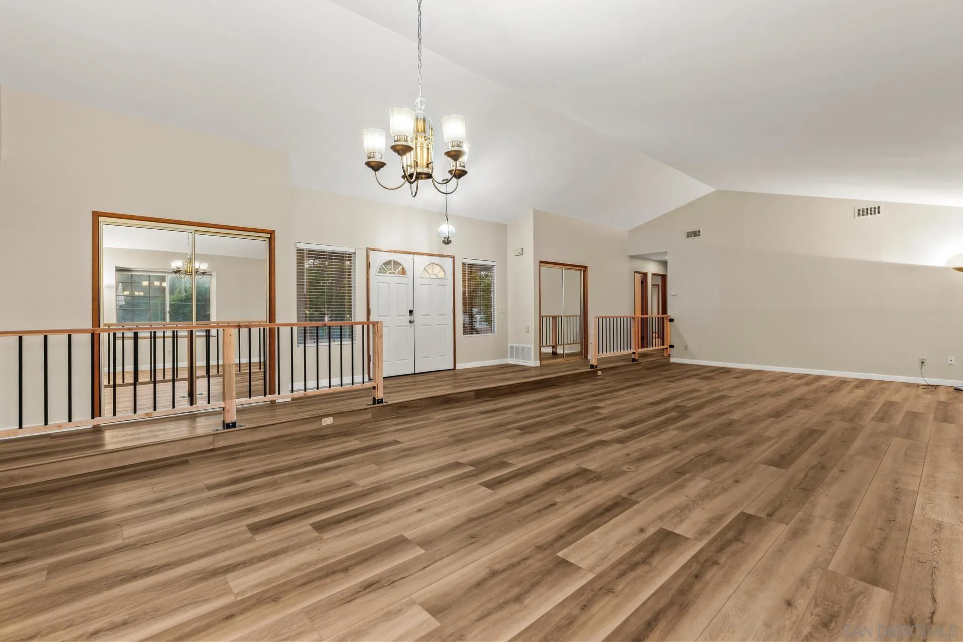 539 Steffy Road Ramona, CA 92065 - Photo 21 of 60 an empty room with wooden floor and chandelier