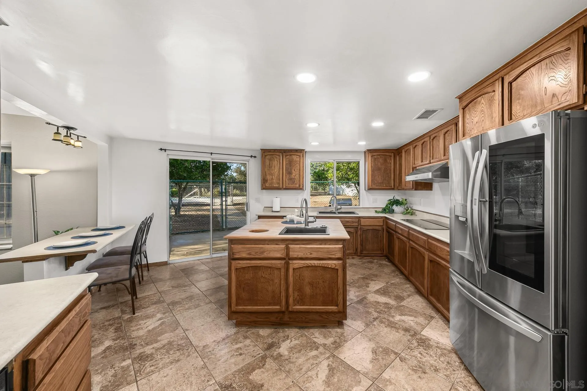 539 Steffy Road Ramona, CA 92065 - Photo 25 of 60 a kitchen with stainless steel appliances granite countertop a sink stove and refrigerator