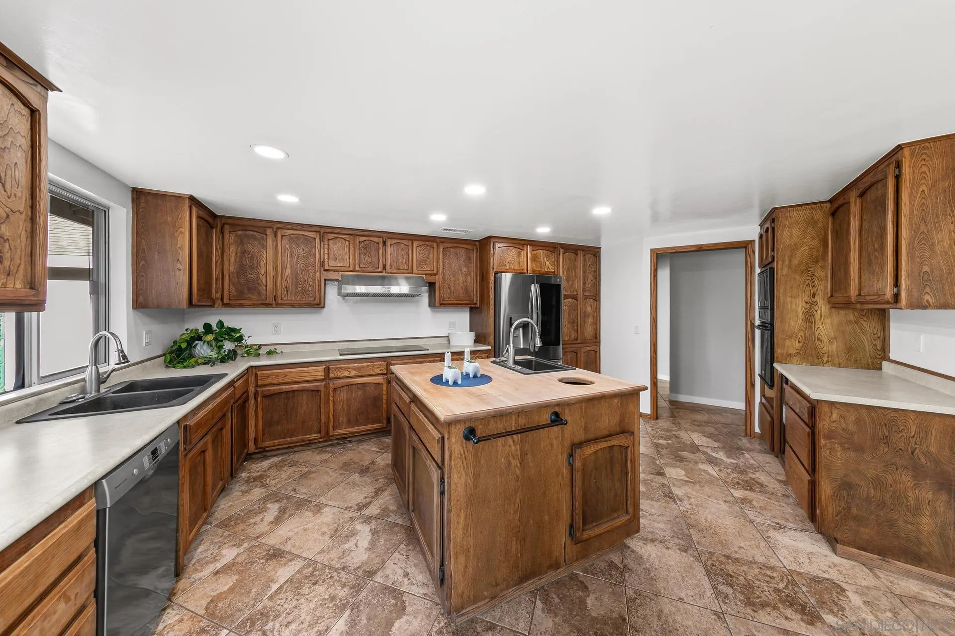 539 Steffy Road Ramona, CA 92065 - Photo 27 of 60 a kitchen with kitchen island granite countertop a sink stove and refrigerator