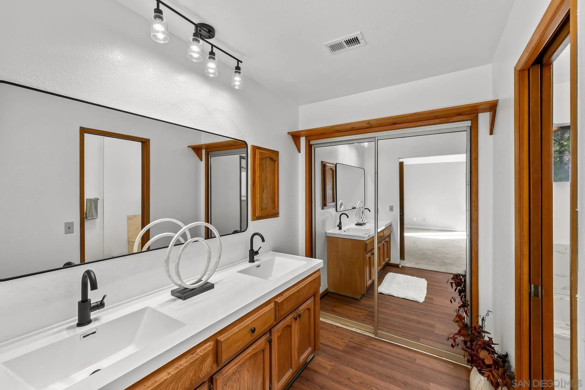 539 Steffy Road Ramona, CA 92065 - Photo 40 of 60 a en suite bathroom with a double vanity sink and mirror
