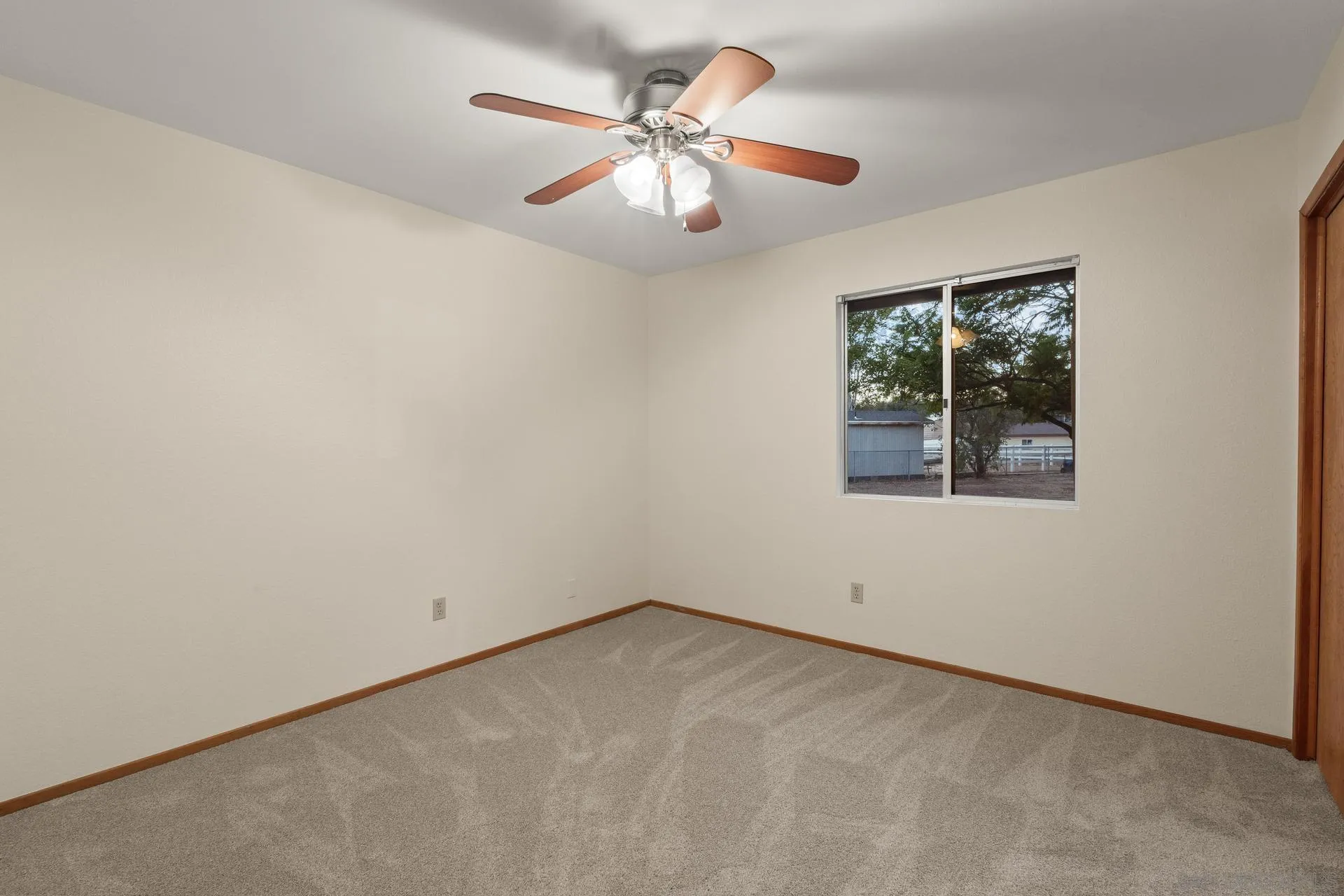 539 Steffy Road Ramona, CA 92065 - Photo 43 of 60 an empty room with a chandelier fan and windows