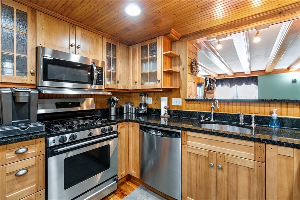 301 Kramer Way Pittsburgh, PA 15211 - Photo 8 of 32 a kitchen with stainless steel appliances a stove a sink and a microwave