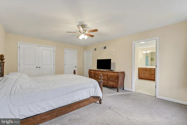 a bedroom with a bed and a tv