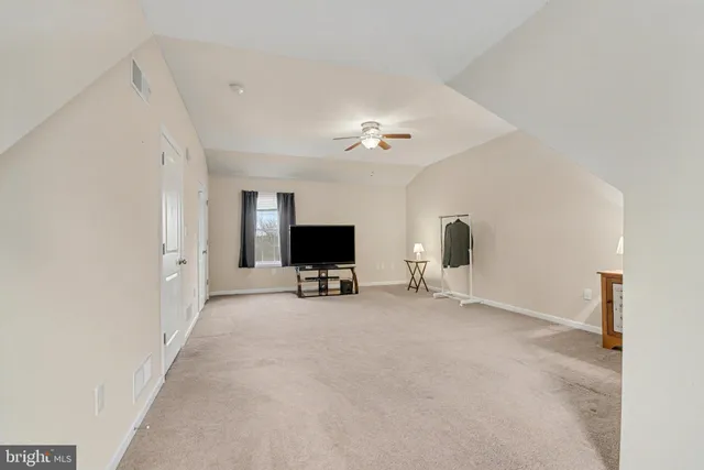 a view of a livingroom with a flat screen tv and a fireplace
