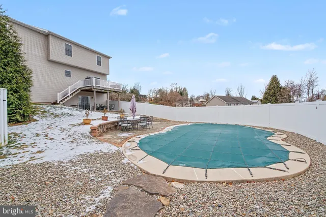 a view of a swimming pool with an outdoor seating
