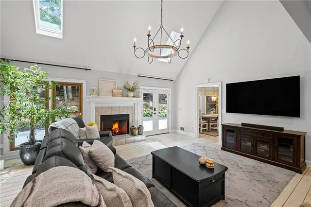 a living room with furniture a flat screen tv and a fireplace