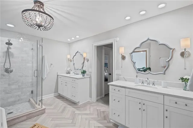 a bathroom with a sink a shower and a mirror