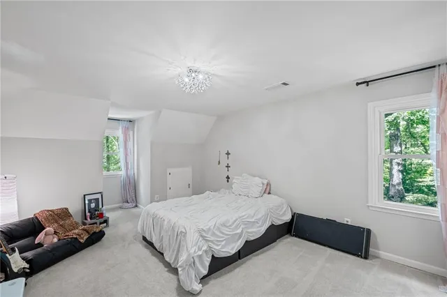 a bedroom with a bed and window