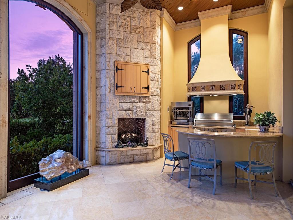 9766 Bent Grass Bend Naples, FL 34108 - Photo 17 of 35 a living room with furniture and a fireplace